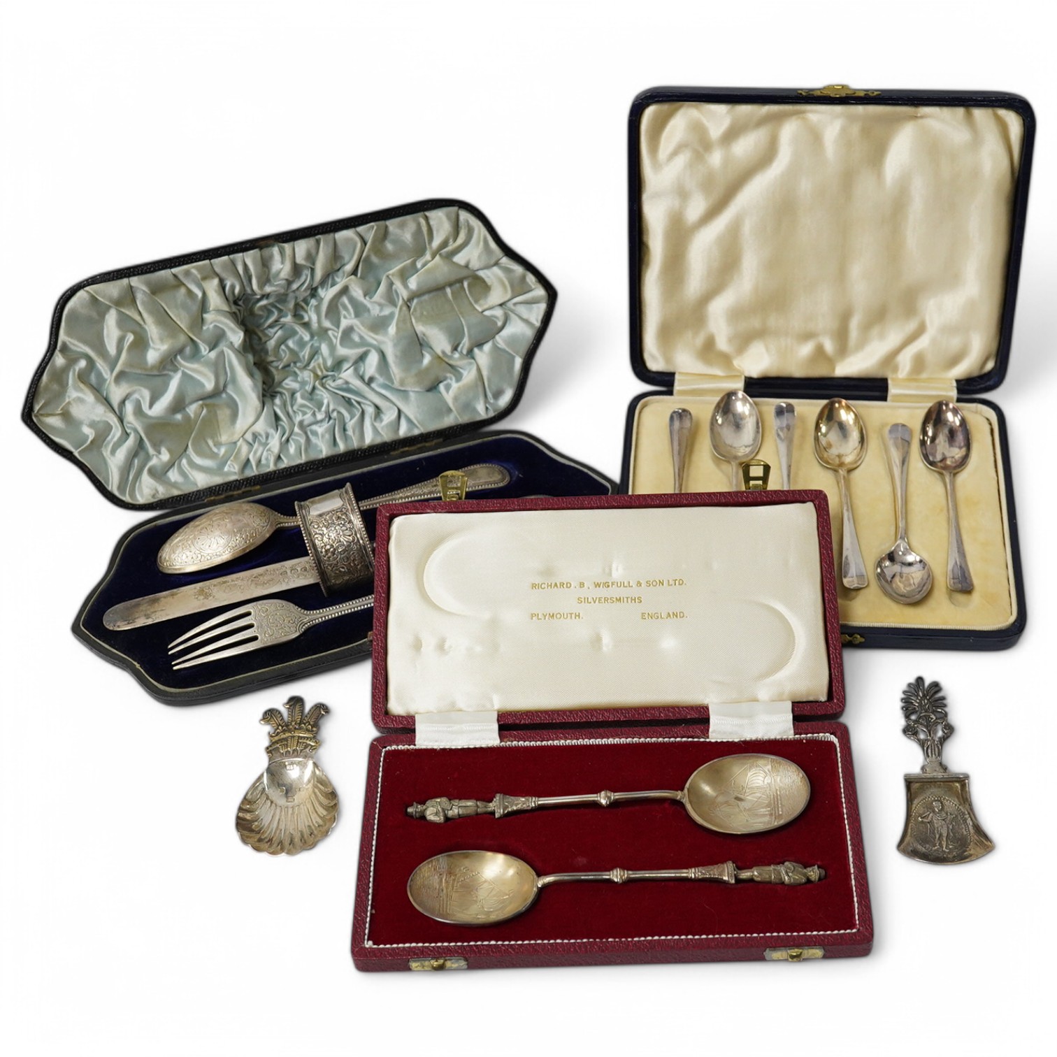 A cased Victorian engraved silver four piece christening set, by William Hutton & Sons Ltd, London, 1895, comprising a spoon, knife, fork and napkin ring, together with a cased set of six silver teaspoons, a cased pair o